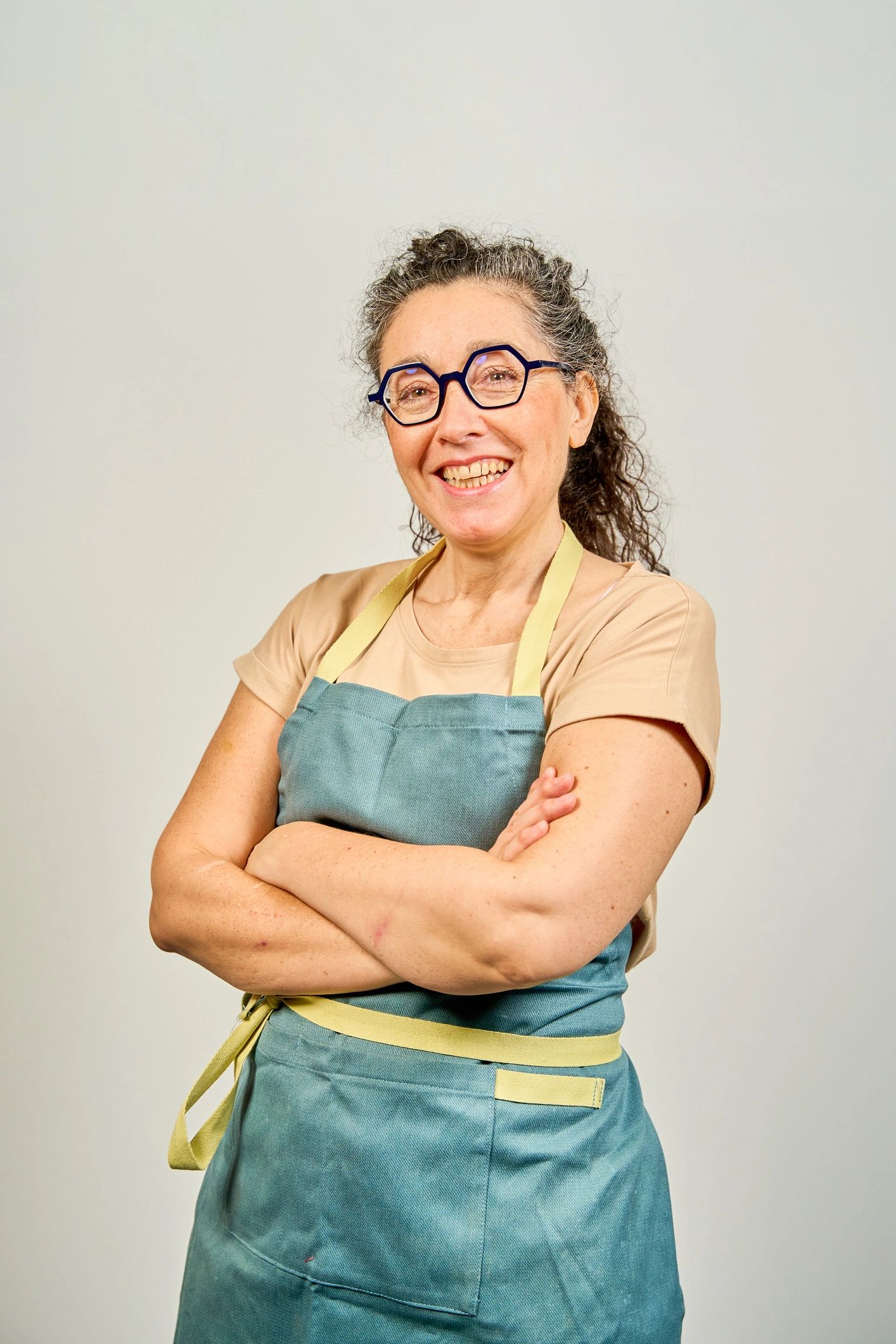 Smiling woman in artist apron