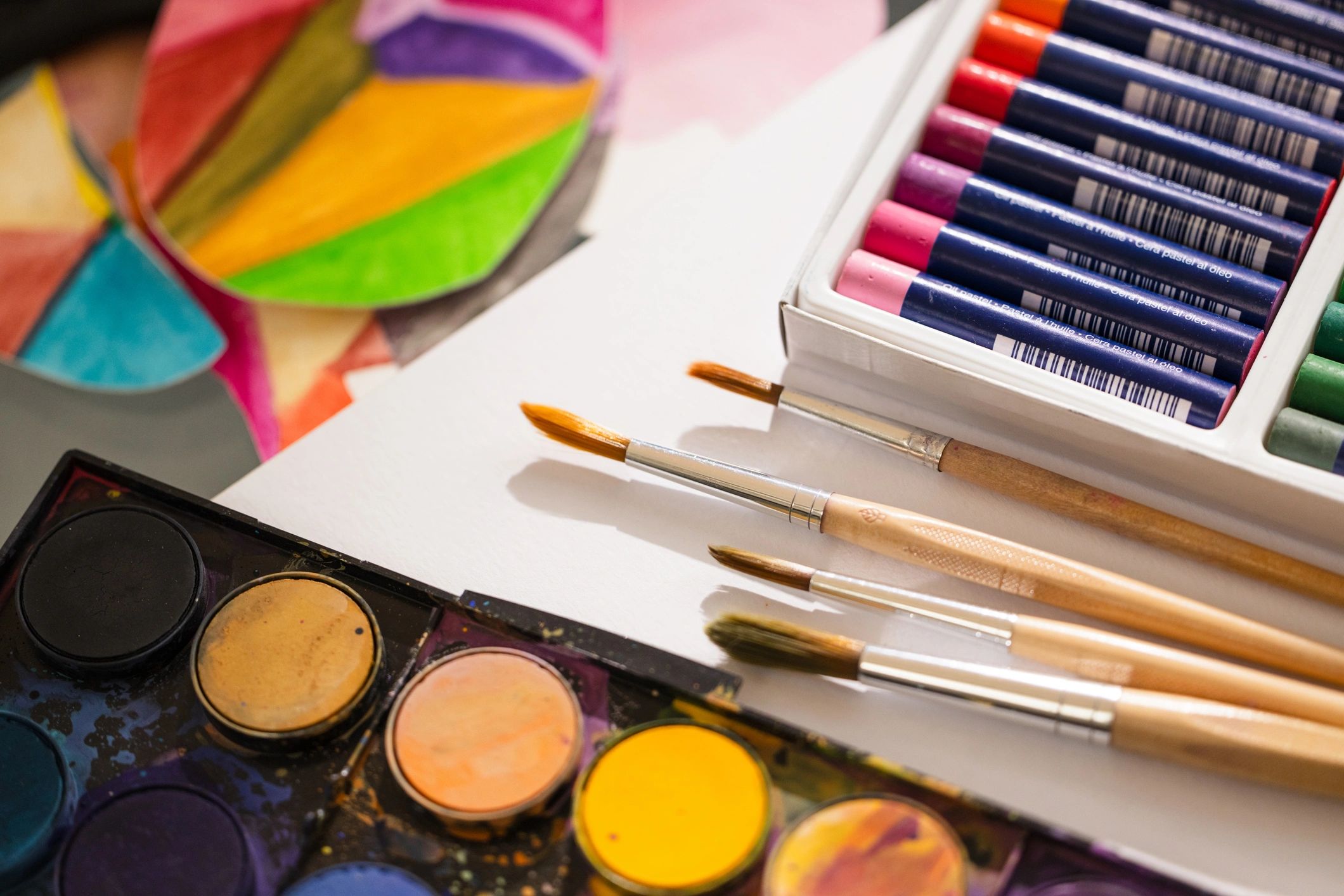 Watercolor paints and brushes symbolizing creativity