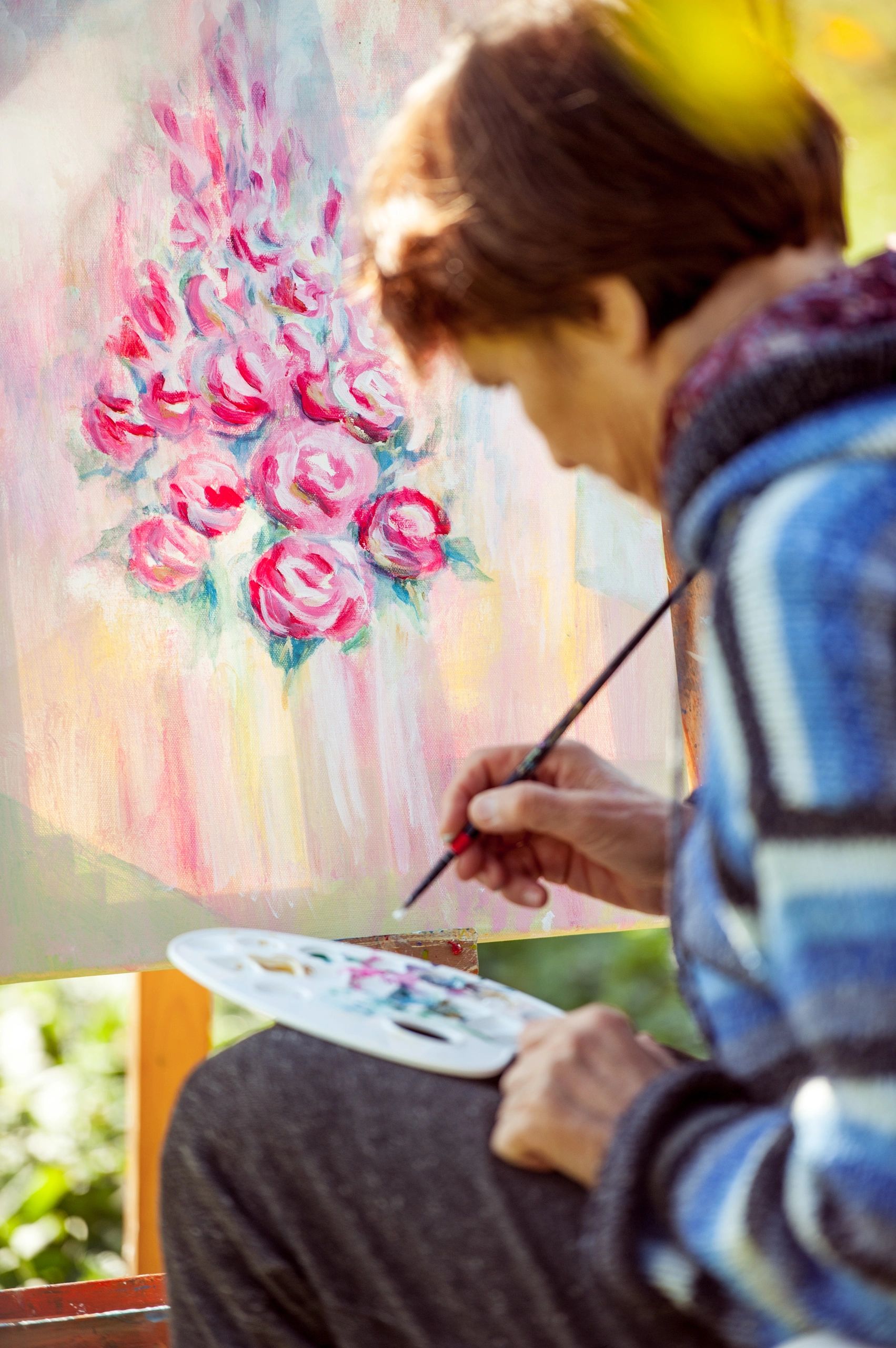Woman artist painting flowers